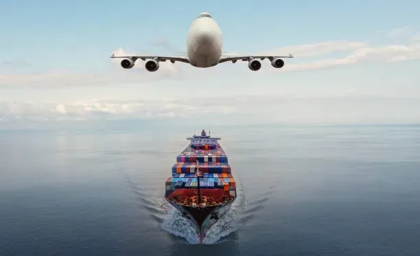 Cargo plane flying low above a loaded container ship at sea