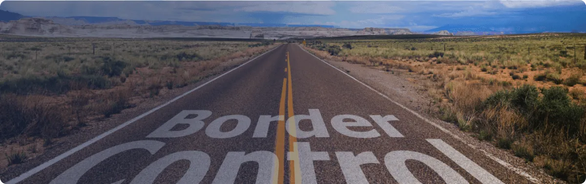 Desert highway with Border Control painted on the road